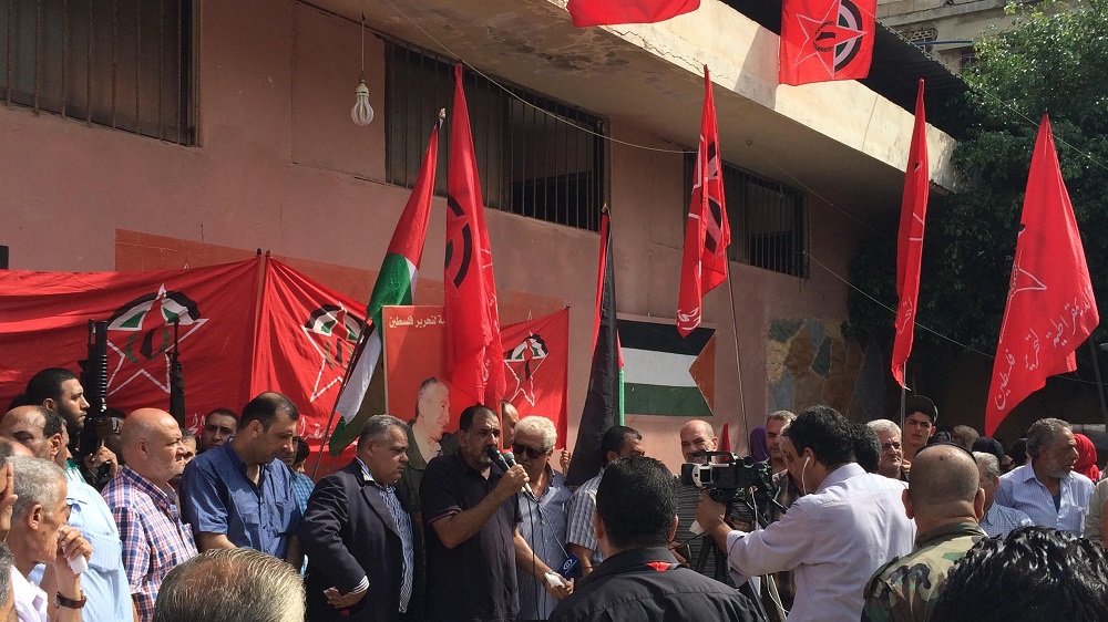 The image contains a group of people and flags. It is taken by the author on field work.